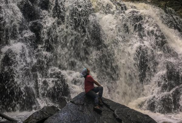 Conservation Corps Crew Member Nicole Vargas at the waterfall at Ramapo Valley County Reservation.